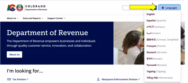 This image shows a screenshot of the Colorado Department of Revenue homepage. A prominent yellow arrow points to the "Languages" button located in the top right corner of the screen. The language menu is expanded, revealing a drop-down list of available translation options such as Español, Arabic, and Korean.